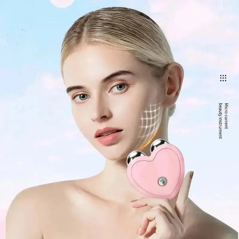Woman demonstrating use of pink heart-shaped microcurrent face lifting massager for skin toning and rejuvenation