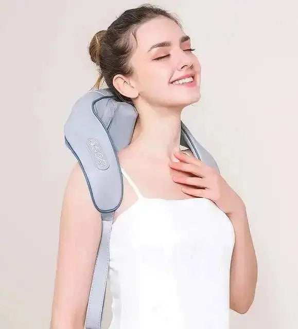 Woman using neck and shoulder massager with heat, enjoying relaxation and relief.
