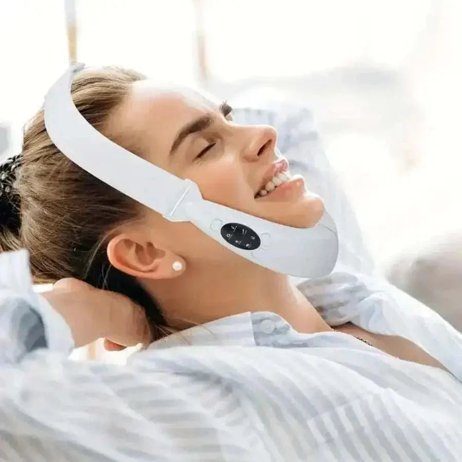 Woman using rechargeable V-Line Face Lifting Device for jawline contouring and skin tightening with LED display on white background